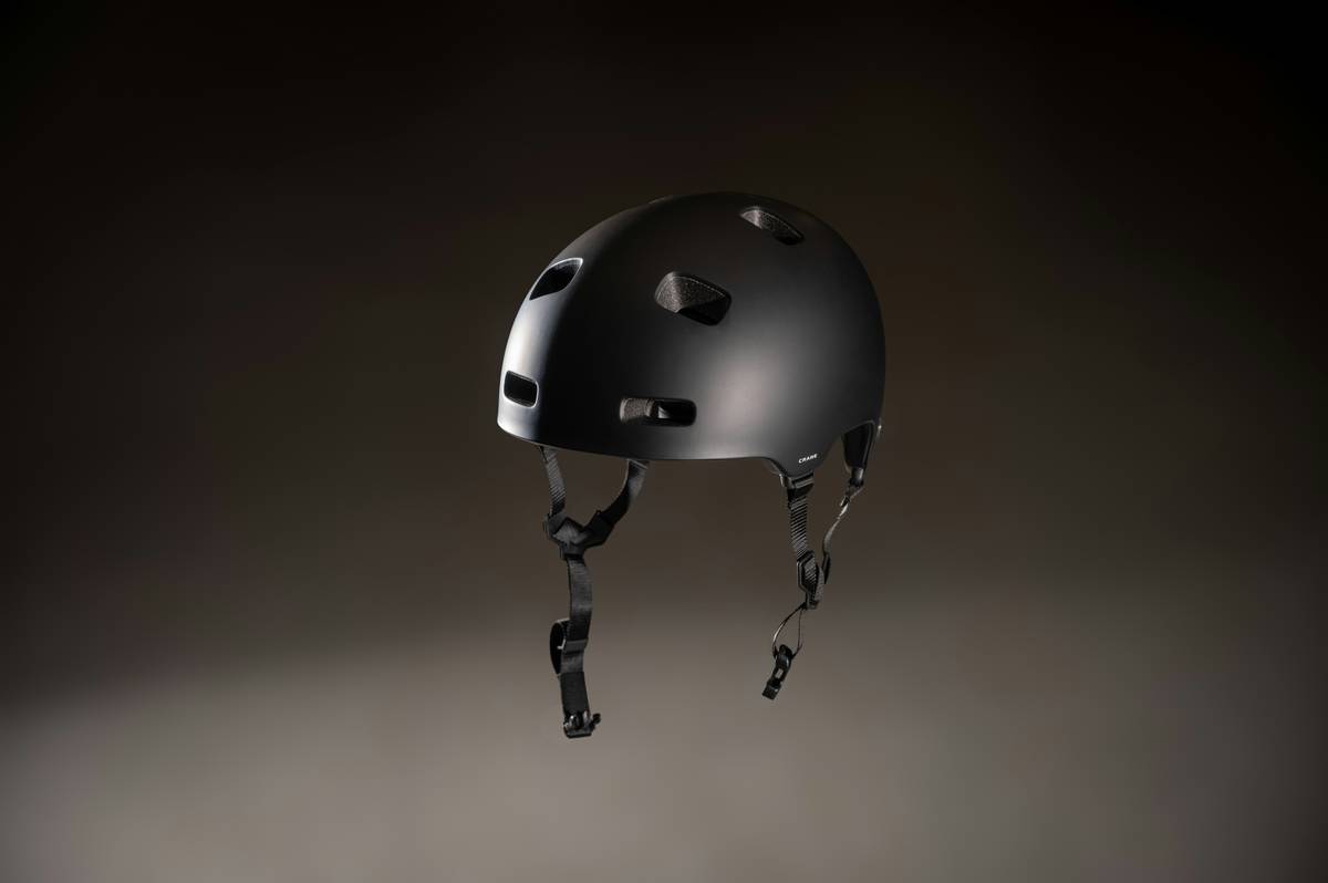 Climber adjusting helmet Temperature Regulation Systems at high altitude