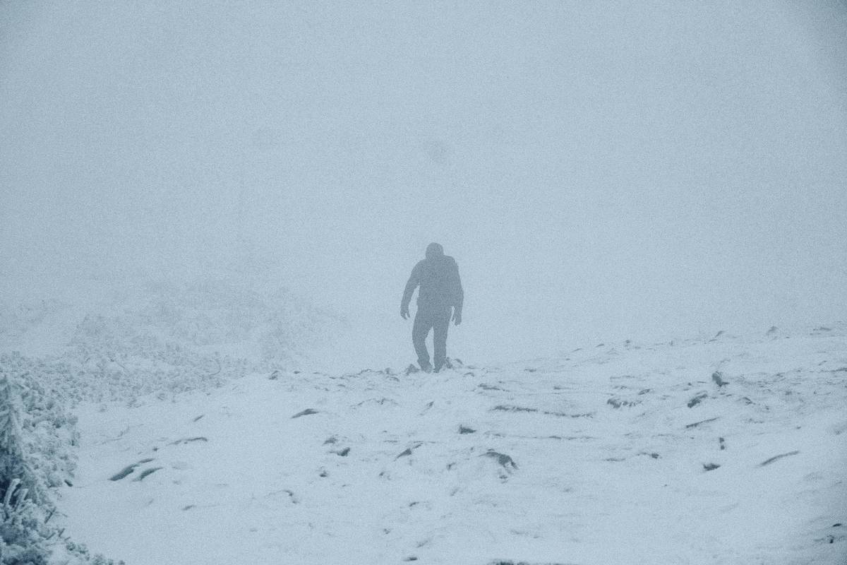Extreme Weather Helmets tested in snowy alpine environment with ice axe and layered clothing